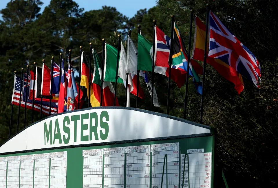Official leaderboard scoreboard at Augusta National showing final scores with McIlroy at −12 and Scheffler one stroke behind
