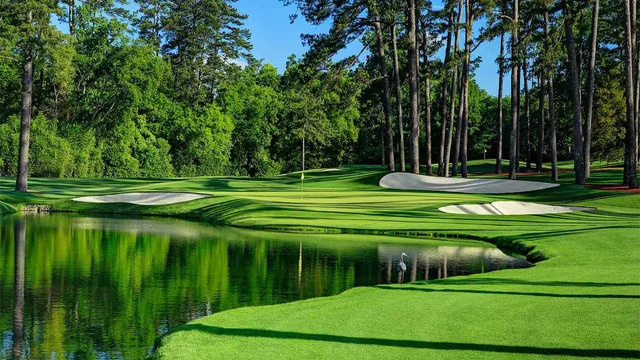 Golfers and patrons walking along the first hole, traditional paths lined with spectators and pines