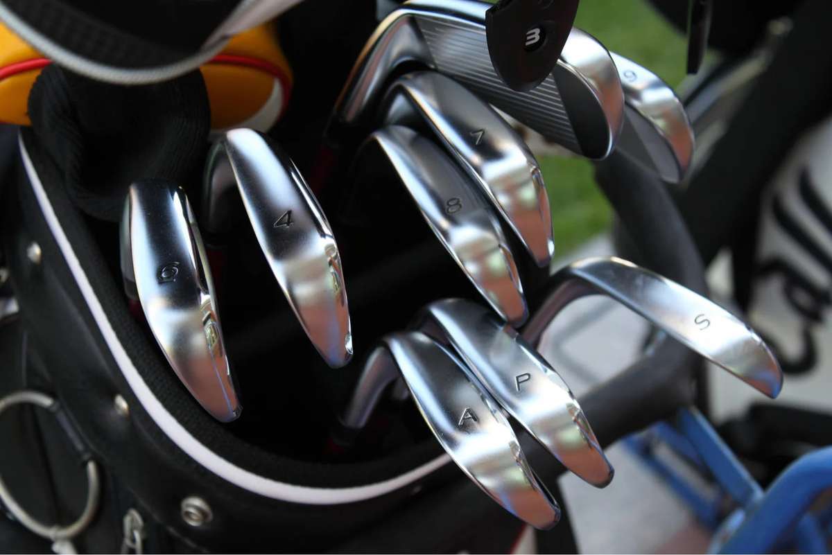 Club fitter adjusting shaft and loft during a progressive fitting session for a new golfer