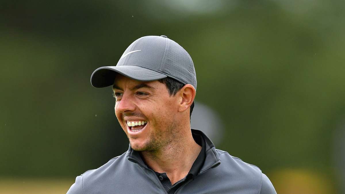 Tiger Woods hitting a long drive in the 2000s, focused expression and athletic posture