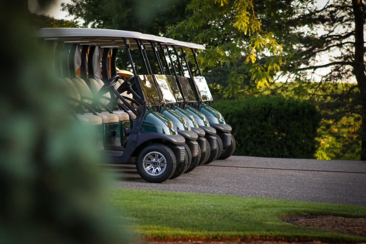 Wide view of a tree-lined fairway at Bethpage Black showing tight angles and a narrow landing area