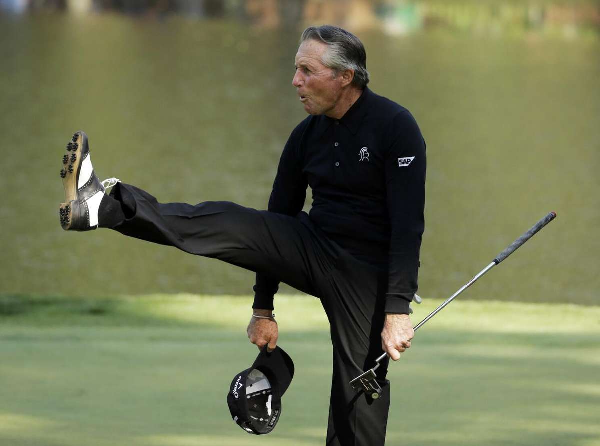 Gary Player doing fitness training with resistance bands beside a golf course, highlighting his commitment to conditioning